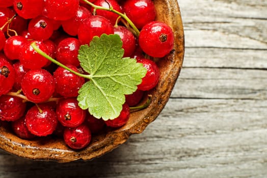Fresh redcurrant berries on wooden background close up