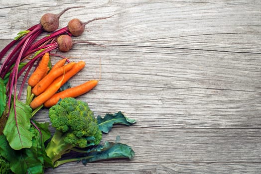Assortment of fresh vegetables and ingredients on wooden rustic table. Vegetable healthy background