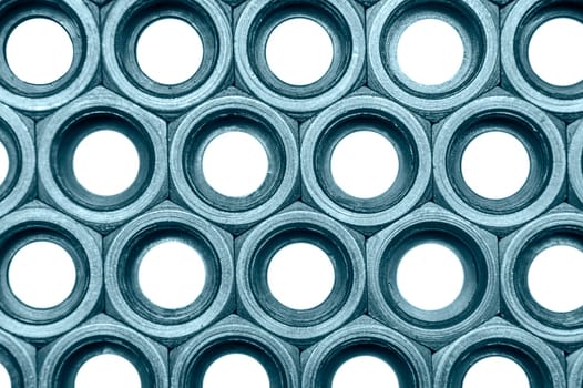 Full-framed arrangement of monochrome union nuts isolated on white.