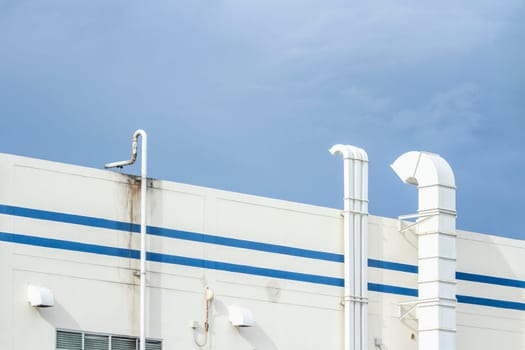 Several white ventilation vents are located next to the building.