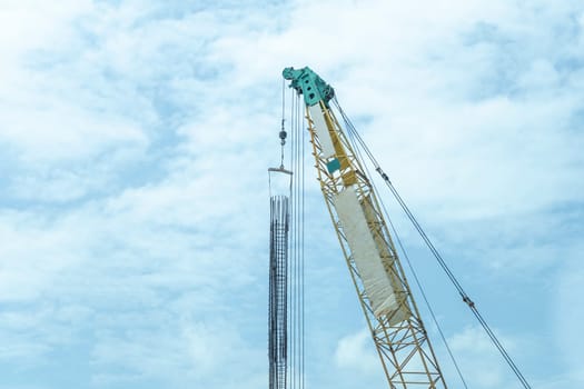 Crane lift green and yellow In the blue sky