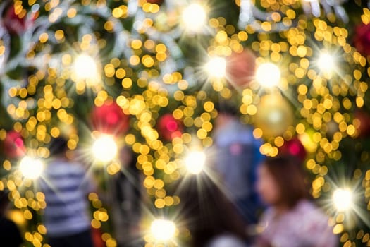 Conceptual defocused Christmas decoration on city street at night