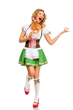 Creative concept photo of Oktoberfest waitress wearing a traditional Bavarian costume with pretzels isolated on white background.