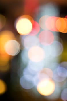 Blurry background image of defocused colorful abstract city street lights at night