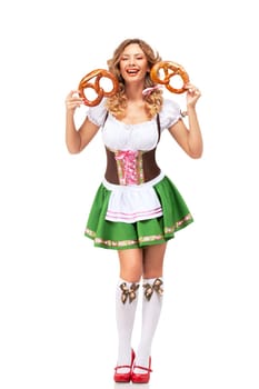 Creative concept photo of Oktoberfest waitress wearing a traditional Bavarian costume with pretzels isolated on white background.