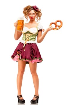 Creative concept photo of Oktoberfest waitress wearing a traditional Bavarian costume with beer and pretzel isolated on white background.