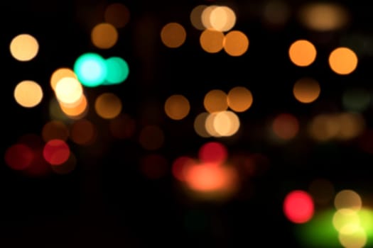 Blurry background image of defocused colorful abstract city street lights at night