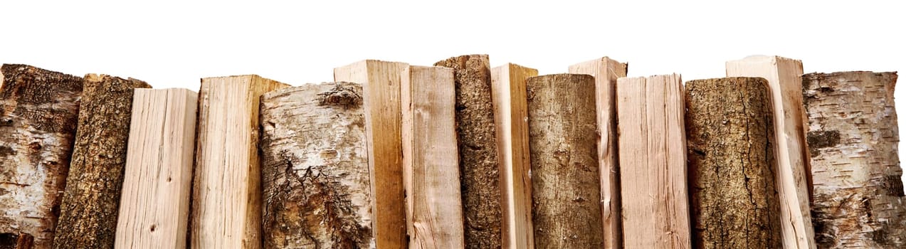 Chopped logs with rough brown bark piled on each other over plain white background. Includes copy space.