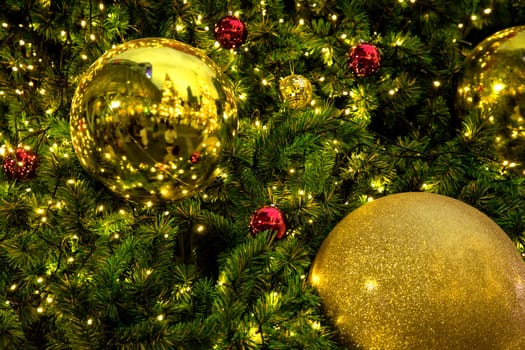 Conceptual image of decorated Christmas tree with colorful lights and ornaments