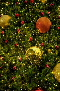 Conceptual image of decorated Christmas tree with colorful lights and ornaments