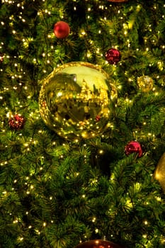 Conceptual image of decorated Christmas tree with colorful lights and ornaments