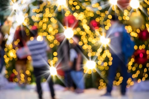 Conceptual defocused Christmas decoration on city street at night
