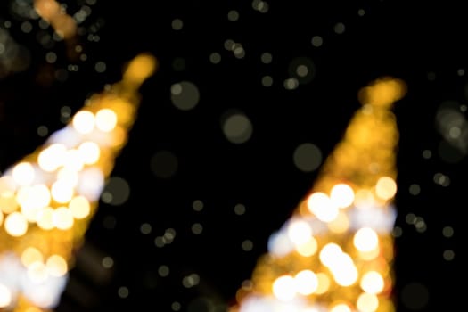 Conceptual background image of defocused abstract Christmas Tree on city street at night