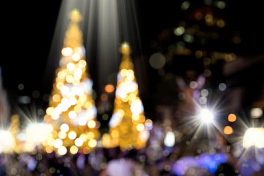 Conceptual background image of defocused abstract Christmas Tree on city street at night