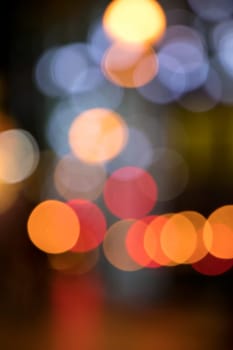 Blurry background image of defocused colorful abstract city street lights at night