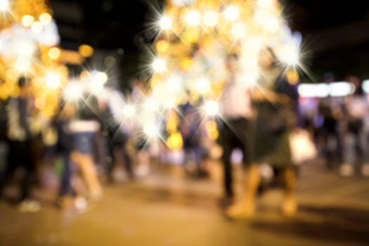 Conceptual abstract background image of defocused Christmas decoration on city street at night