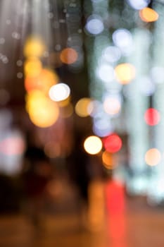 Conceptual abstract background image of defocused Christmas decoration on city street at night