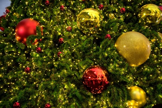 Conceptual image of decorated Christmas tree with colorful lights and ornaments