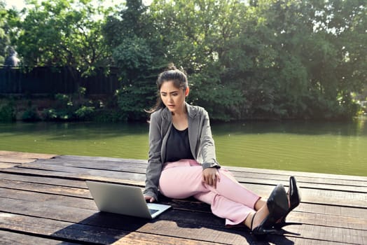 Young asian business woman working with laptop at outdoor