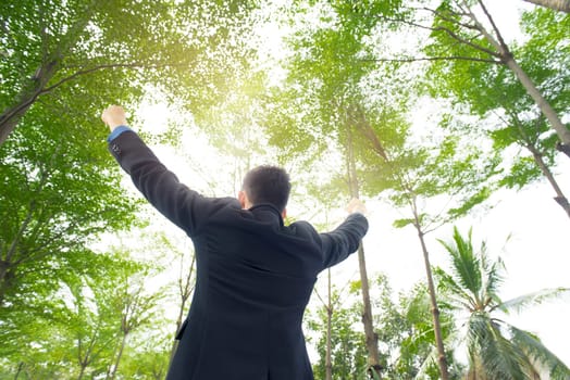 Portrait of happy asian businessman standing at outdoor