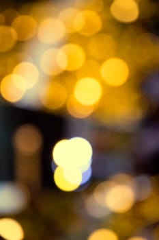 Blurry background image of defocused yellow abstract city street lights at night