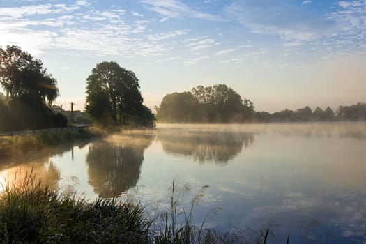 Early morning at the pond with a film of mist