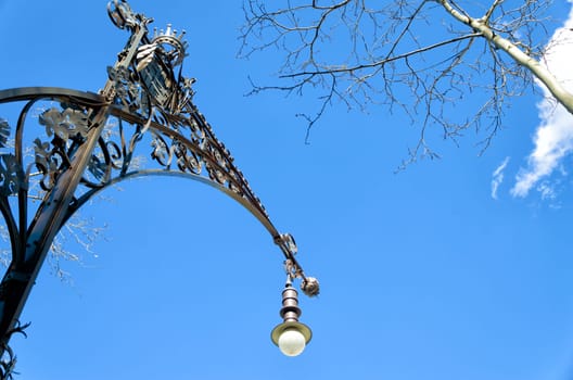 View of orante street light with tree in Barcelona, Spain