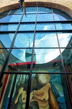 FIGUERAS, SPAIN - MARCH 9: Window with painting and reflection on Salvatore Dali Museum in Figueras, Spain on March 9, 2018