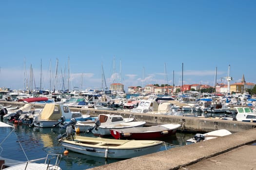 Marina with many ships in front of the old town of Porec in Croatia