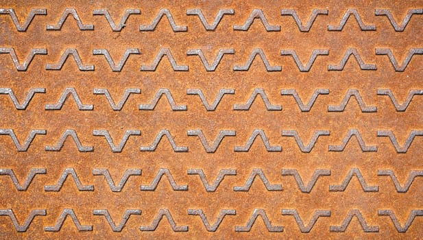 Background with metallic textures pattern. Close-up of a rusty manhole.