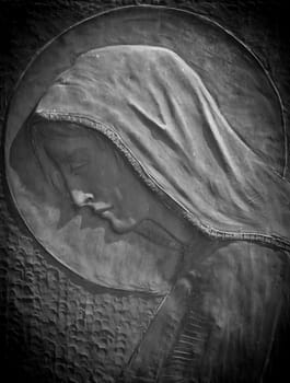 Bas-relief of the Virgin Mary with the veil. Marble monument.