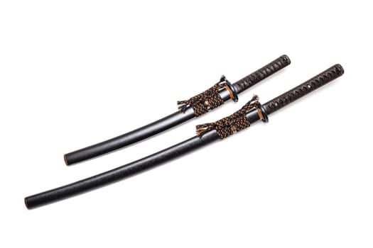 Brown leather cord tie on grip Japanese sword and black scabbard with steel fitting isolated in white background.