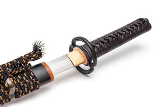 Brown leather cord tie on grip Japanese sword steel fitting and black scabbard on white background.