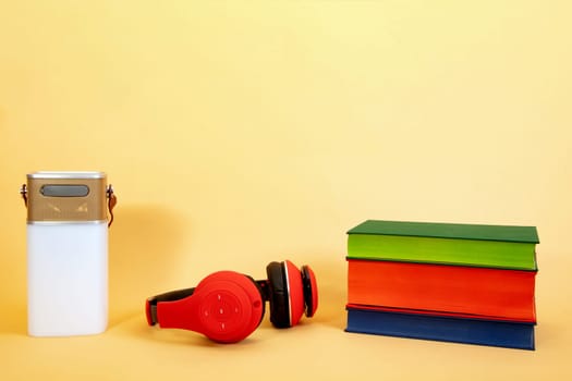 Electronic equipment smart speaker, Headphone and Books on beige Background