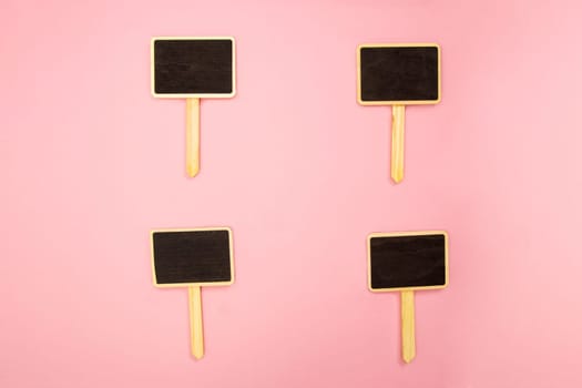 Four little blank chalkboards on pink paper