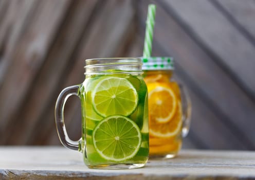 Lemonade in a glass mug-bank on the background of a wooden wall