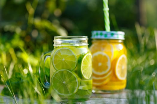 Lemonade in a glass mug-bank on a background of green grass