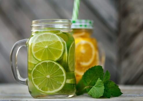 Lemonade in a glass mug-bank on the background of a wooden wall