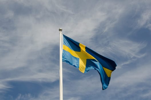 the swedish flag against a blue sky a beutiful summerday