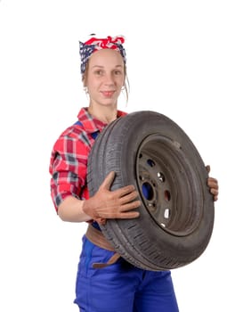 young woman mechanic with a car wheel on the white background