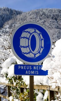 road sign on a snowy road on mountain