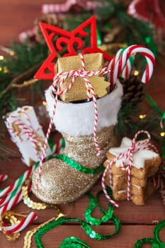 Little Santa Claus boot with christmas presents and festive decorations
