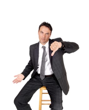 A handsome man in a suit and tie sitting and signing thump down.in disapproval, looking serious, isolated for white background.