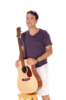 A handsome young man standing in a burgundy shirt and shorts .holding his guitar, isolated for white background.