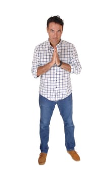 A tall handsome man standing and praying with his hands folded, .praying to God, looking, isolated for white background.
