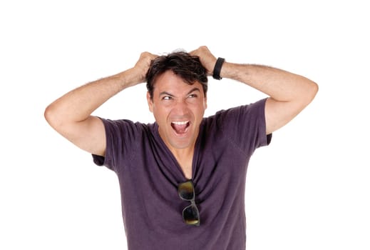 A tall man in a burgundy shirt screaming and messing up his hair.with his mouth open, isolated for white background.