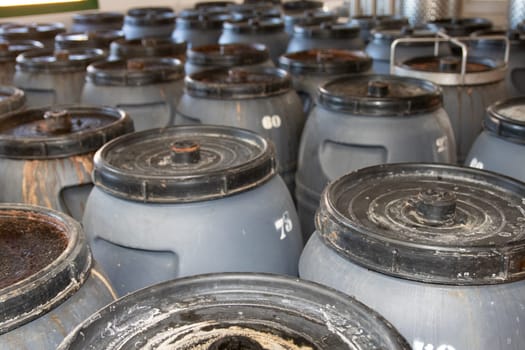Olives factory. Olives in metal barrels in an interior plant for the production of olive oil on Cran Canaria. Concept of nature and healthy food.
