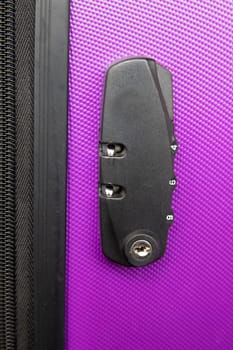 Top view on suitcase combination lock on purple suitcase. Concept travel safety and insurance.