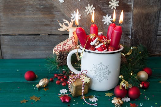 Rustic mug with colorful festive decorations for a merry christmas