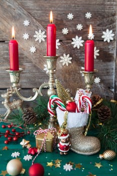 Little Santa Claus boot with christmas presents and festive decorations